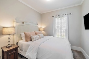 Bedroom 1: Queen bed, comfortably sleeps 2 guests.