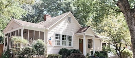 Welcoming front and screened side porch, spacious front lawn, private driveway