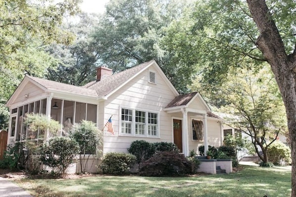 Welcoming front and screened side porch, spacious front lawn, private driveway