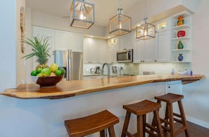 Custom wooden bar along the kitchen. It is even more beautiful in person