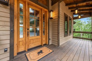 Oversized front porch with gabled roof and 8' entry door to invite you inside.