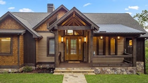 Classic post & beam construction, natural wood materials and stone accents express a timeless mountain rustic flair.