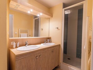 Get ready for your day in the bright bathroom.