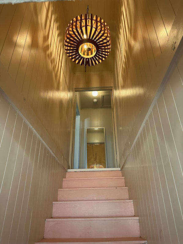 Pink stairs leading up to garage apt. 