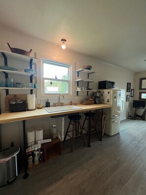 Kitchenette w/full-sized fridge, microwave, coffee maker. 