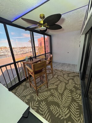 4 privacy tinted windows open revealing a screened lanai with ceiling fan breeze