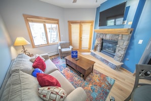 Large flat screen tv and a gas fireplace to enjoy on a snowy night