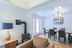 Living room, looking into the dining room and patio door.