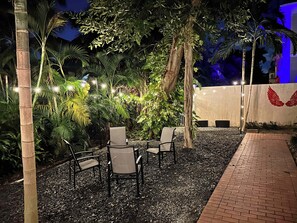Outdoor string lighting makes the backyard a relaxing place to have a conversation at night time!