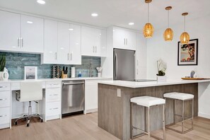 Kitchen is complete with kitchen wares and has brand new built-in designer appliances.  Additional workplace as well.