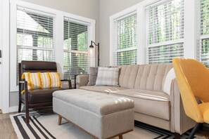Modern Living Room with Large Windows Letting In Lots of Natural Light.
