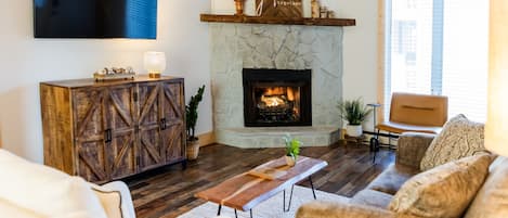 Living room with gas log fireplace & 58" Smart TV