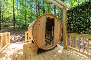 Outdoor barrel sauna available for use on property - shared between both cabins.