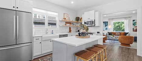 Fully stocked kitchen with counter seating and built in breakfast nook