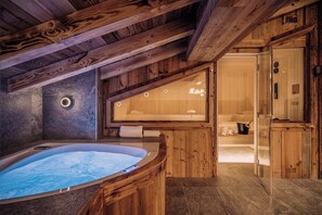 Relax and soak in the private hot tub after a day on the pistes.