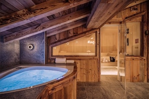 Relax and soak in the private hot tub after a day on the pistes.