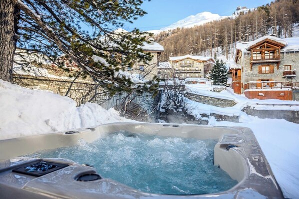 Indulge in relaxation and scenic views from the outdoor jacuzzi on the terrace.