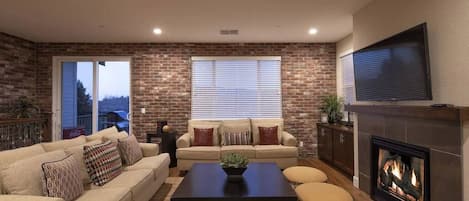 Living room with seating for 10 around the fireplace