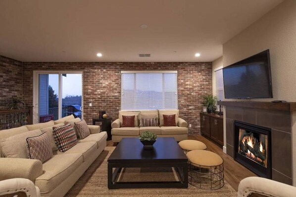 Living room with seating for 10 around the fireplace