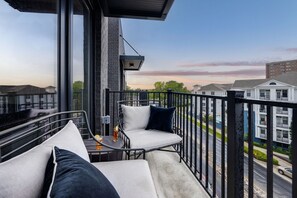 Private balcony featuring outdoor lounging and neighborhood views. The perfect setting for a cup of Joe in the morning.