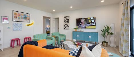 Spacious open floor plan with funky Andy Warhol inspired designer decor featuring multiple seating, smart TV, and access to private patio.