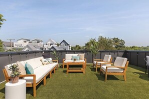 Private rooftop deck with plenty of seating and lounging space for you to relax in the sun or dine al fresco.