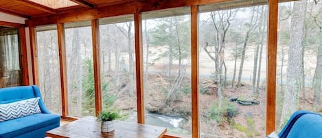 Read a book in these comfy chairs  or take in the view of the creek with these floor to ceiling windows. 