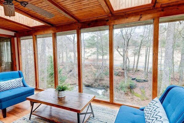 Read a book in these comfy chairs  or take in the view of the creek with these floor to ceiling windows. 