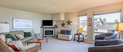 Living room offers a stunning view and a cozy propane fireplace.