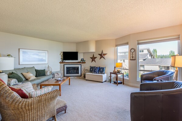 Living room offers a stunning view and a cozy propane fireplace.