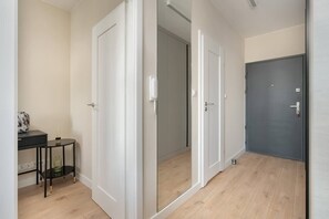 A hallway featuring a small console table with decorative elements and neutral tones, adding a touch of sophistication.

