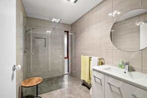 Newly renovated bathroom with sleek walk-in shower.