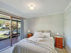 Retreat to Bedroom 1 with a luxurious queen bed for a restful night's sleep.