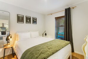 The Queen bedroom is relaxing with its neutral colour scheme of white and green.