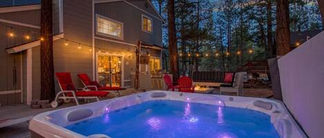 Romantic back deck with spa and fire pit.