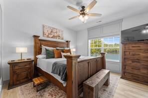 Experience luxury in our master suite featuring a king bed with a serene view.