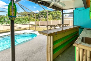 Private pool with hot tub and tiki bar in a screened enclosure 