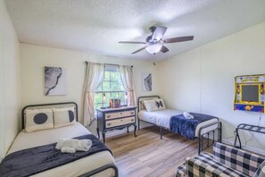 Twin bedroom. Books and PAC-MAN video game.