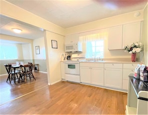 Fully equipped kitchen includes refrigerator/freezer, microwave, range, oven, toaster, coffee maker and coffee, baking pans and bowls, pots, place ware, utensils