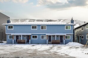 An exterior view of the building the home is located in. Two reserved parking places directly in front of the condo are included.