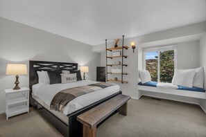 A beautiful master bedroom has everything you need for a good night’s sleep with a queen-size bed, access to the shared bathroom, and a lovely window seat.