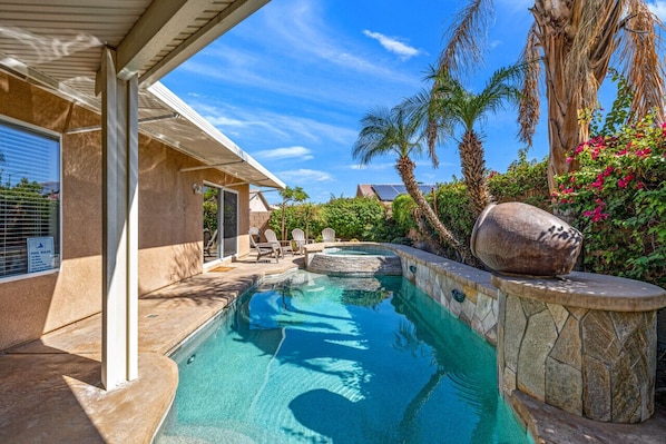 Private and heated swimming pool surrounded by landscape