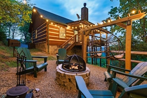 Relax in our private outdoor backyard with a FirePit and a Pergola with Hanging Egg Chairs.