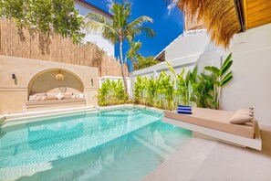 Featuring a lagoon style pool with beach entry