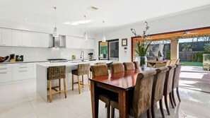 Aroha Moana Dining Table and Kitchen leading out onto Outdoor Area
