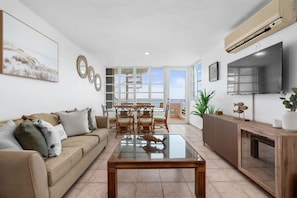 The living room with access to an oceanfront balcony