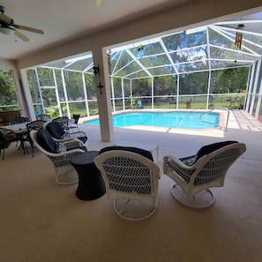 Lanai Patio Set with additional table and 6 chairs located by the outside bar