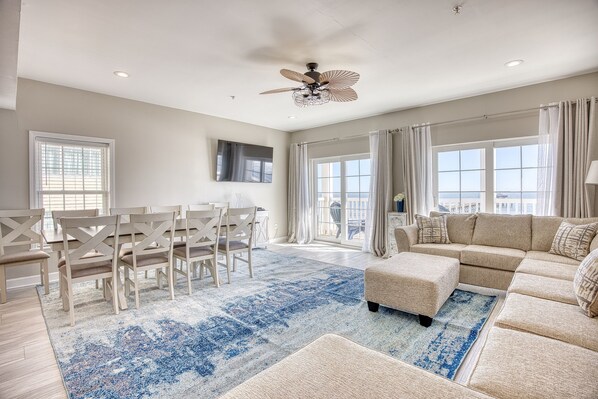 Living Room and Dining Room Table with Ocean Front Balcony View