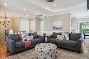 High ceilings & lots of natural light bathe the enormous living room next to dining area & kitchen