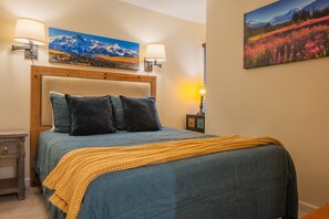 Primary bedroom with queen size bed and TV